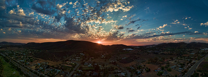 A 5 image aerial panoramic sunset 380' above ground looking West in San Marcos, California, USA.