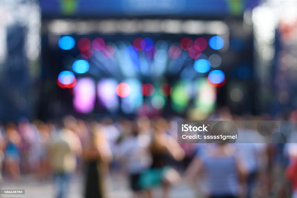 Blurred photo of concert crowd Blurred photo of concert crowd in front of bright stage lights, detail 2015 Stock Photo