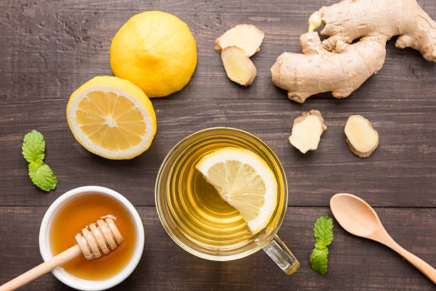 istock Cup of ginger tea with lemon and honey on table. 486640574