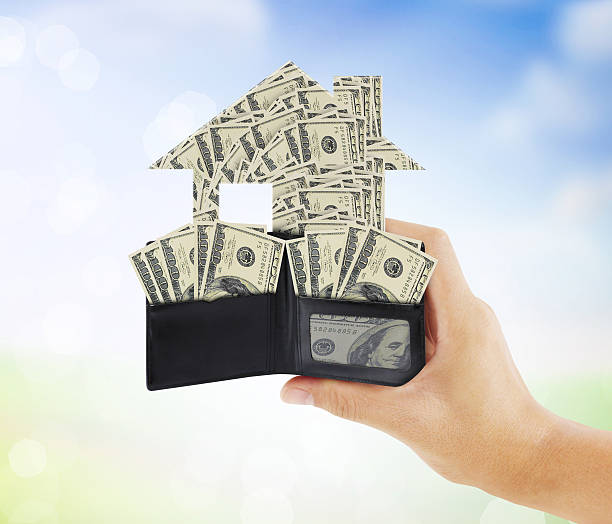 istock Businessman holding  house 486641120