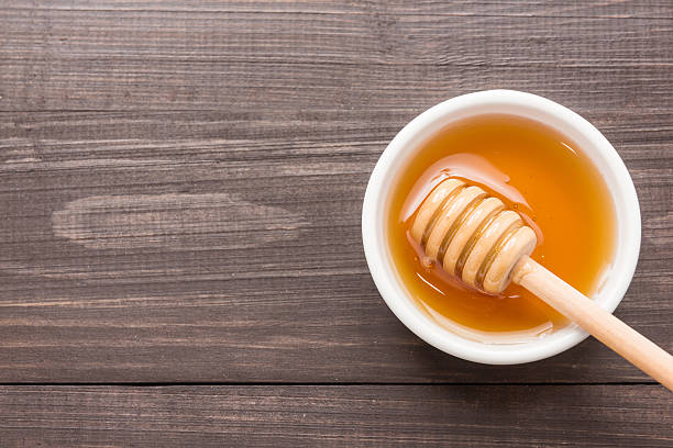 istock Sweet honey on the wooden table. Top view 486642250