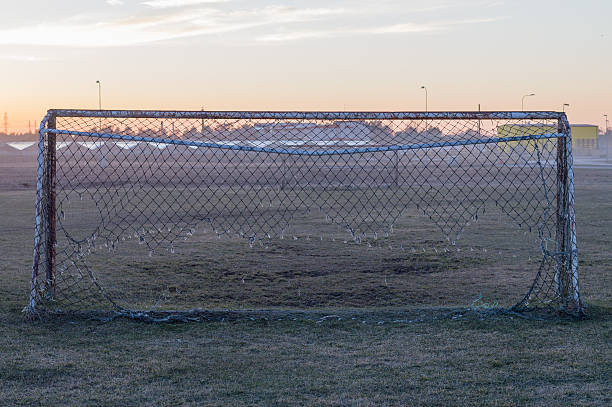 istock Old soccer goal with faulted net 486643662