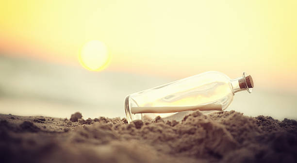 istock Message in a Bottle on sea beach 486643960