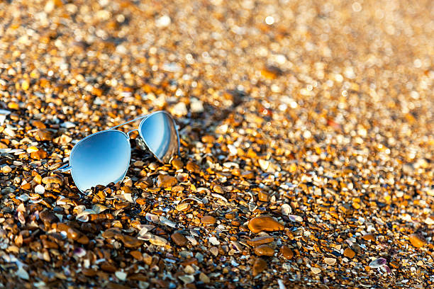 istock sunglasses, beach, reflection, summer, exposure, sand, pebbles, 486644142
