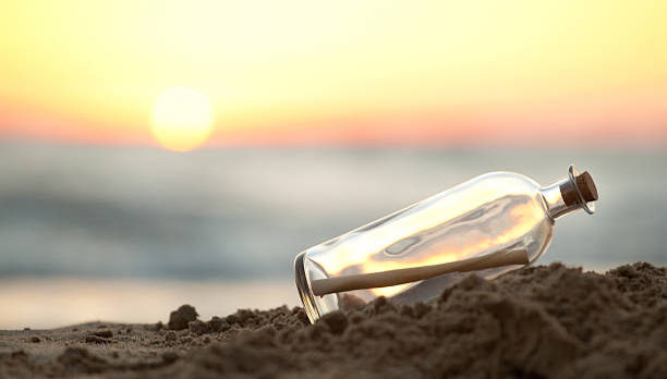 istock Message in a Bottle on sea beach 486644194
