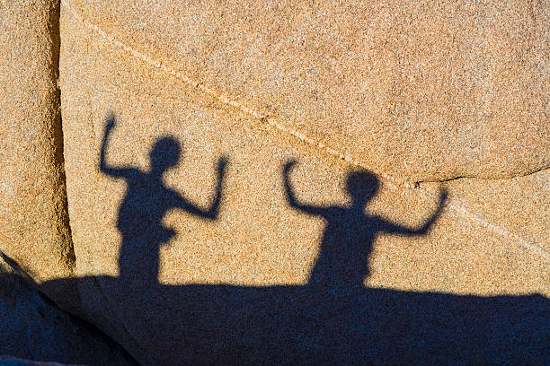 istock children playing with shadows on a rock 486644275