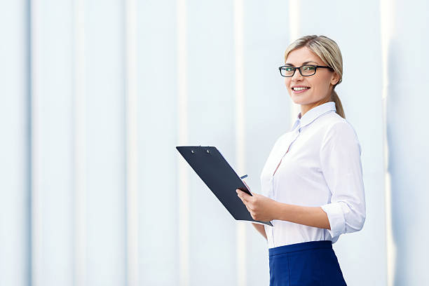 istock Cheerful business woman holding folder 486645384