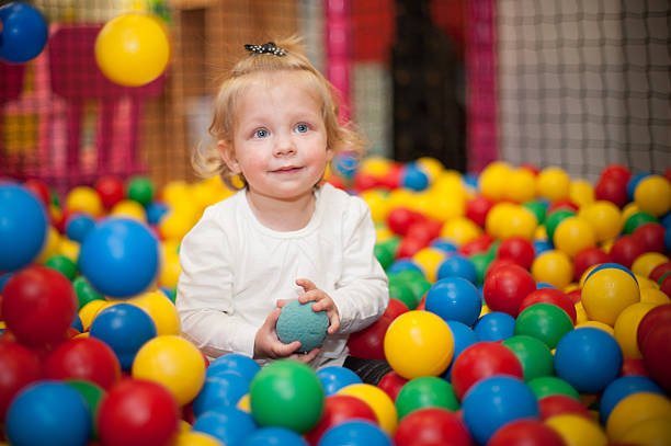 istock Baby girl in ball pool 486645471