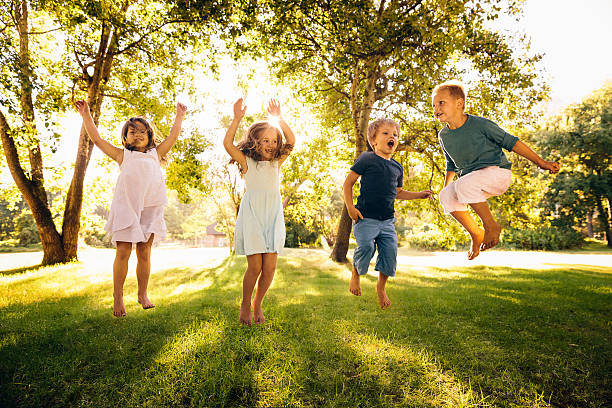 istock Group of kids jumping in park 486645687