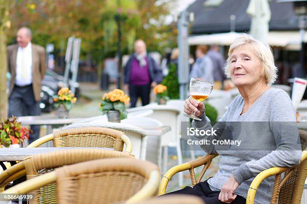 Happy Active Senior Woman Relaxing In Outdoors Cafe Stock Photo - Download Image Now