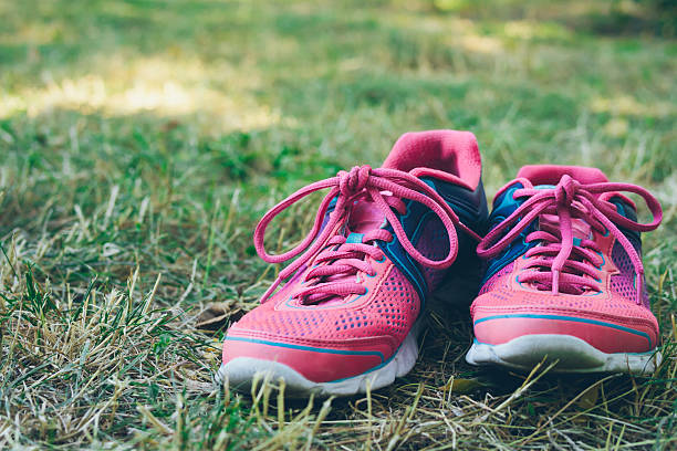 istock Pink and blue sneakers on a green grass 486645956