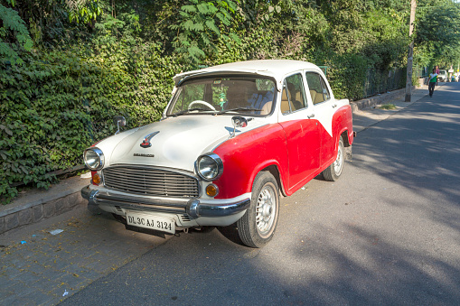 Delhi, India - October 14, 2012: Ambassador car parks at the street in New Delhi, India. The car manufactured by Hindustan Motors of India is in production since 1958 and  based on the Morris Oxford III model.