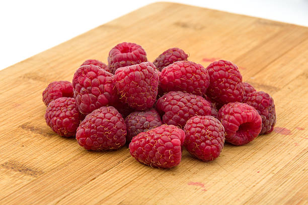 istock Ripe sweet raspberries on wood table close-up 486647802