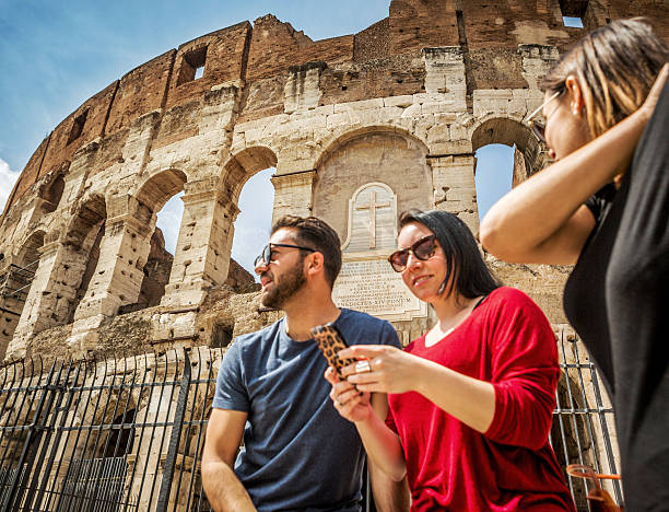 istock Tourists relaxing in front of the Coliseum, Rome 486647893