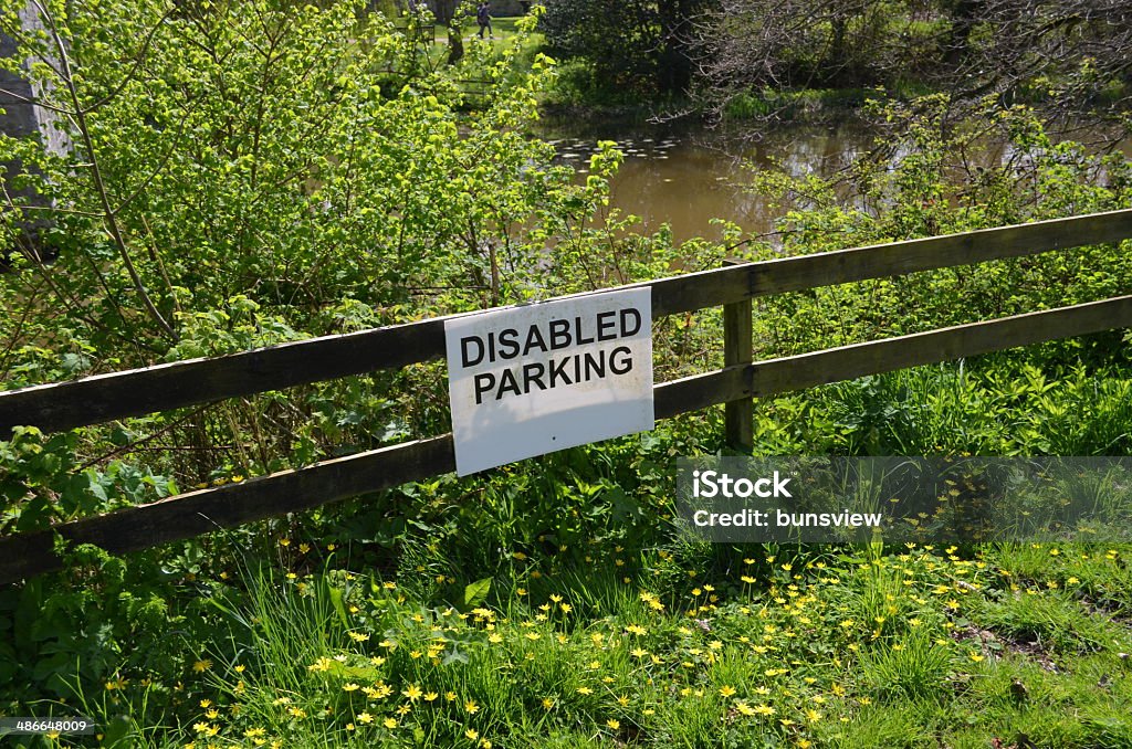 Disabled parking sign. Beside a riverbank a notice informing that the surrounding area is for disabled drivers to park their vehicles. Accessibility Sign Stock Photo