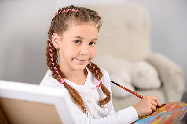 istock Pretty girl painting 486648140