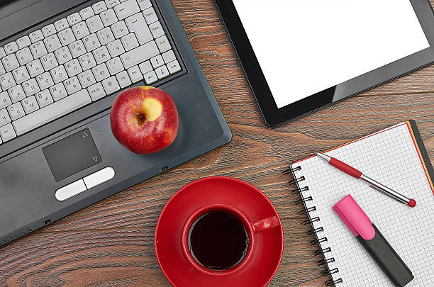 istock Laptop and office supplies on wooden table 486648521