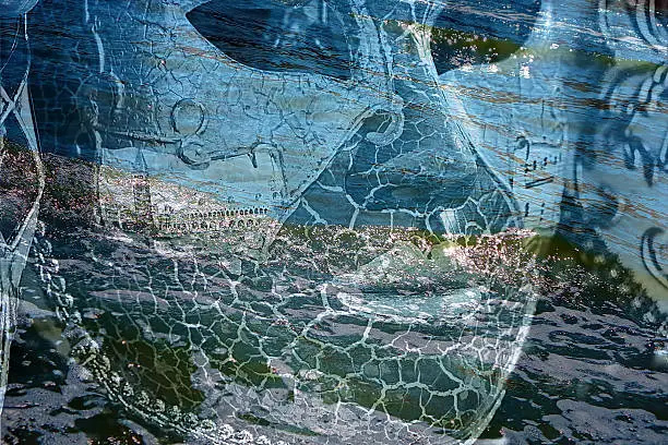 Double exposure with Venetian mask superimposed over the sea.