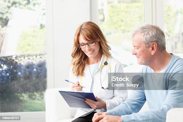 Analyzing Xray Stock Photo - Download Image Now - Female Doctor, Patient, Discussion