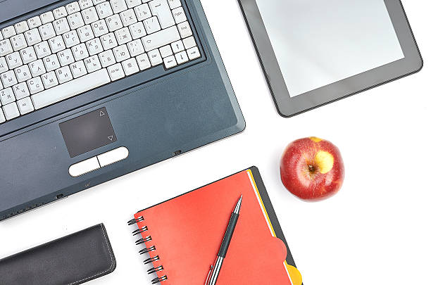 istock Laptop and office supplies on white 486649311