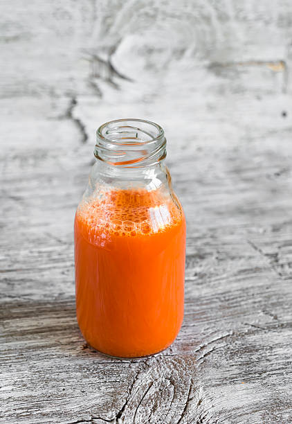 istock fresh carrot juice in a glass bottle 486649990