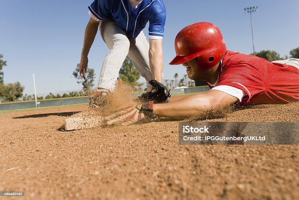 Runner and Infielder Both Reaching Base Baseball - Sport Stock Photo