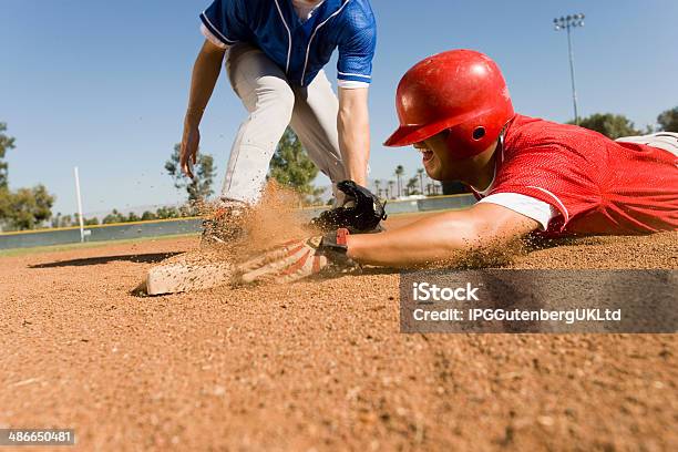 Runner And Infielder Both Reaching Base Stock Photo - Download Image Now - Baseball - Sport, Baseball Player, Teenager