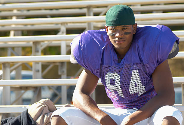 Football Player Watching from Bleachers