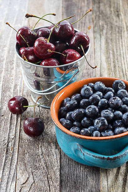 Blueberries and Cherries on a Table stock photo