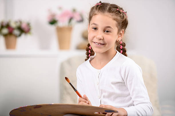 istock Pretty girl painting 486650832