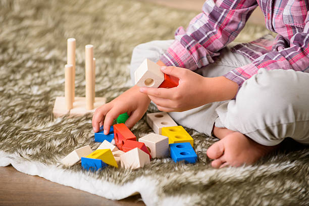istock Cheerful boy playing on the carpet 486652382