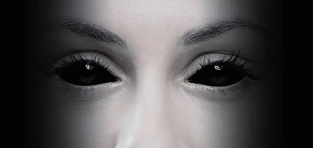 Halloween concept, close up of evil female eyes