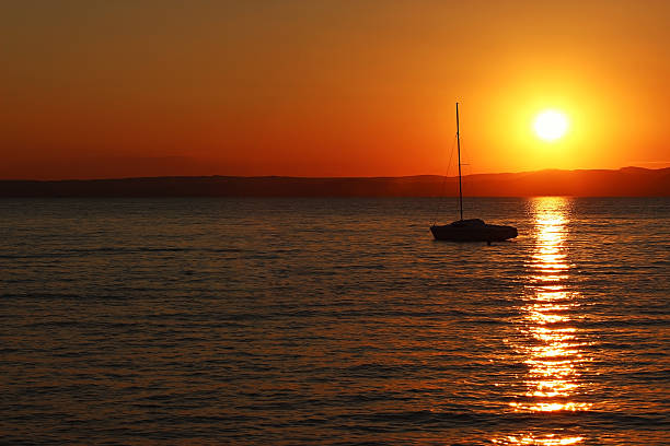 istock Sunset over the lake with ship 486654494