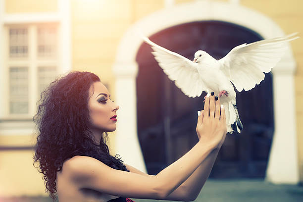 istock Young girl holding a pigeon in her hands 486655594