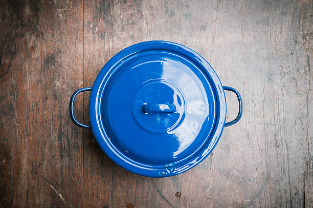 blue of cooking pot on wooden background blue of cooking pot on wooden background cooking pan overhead stock pictures, royalty-free photos & images