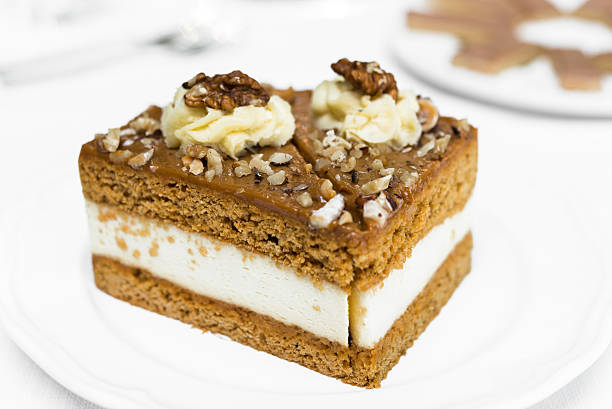 Close up of piece of toffee cream cake on white plate