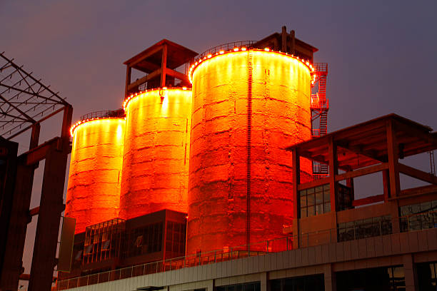 istock Cement silo and production building at night 486658606