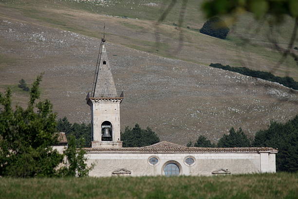 istock Pescocostanzo's basilica peeks out from behind the hill 486658788