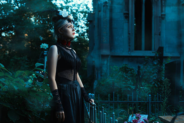 istock Woman stands in a cemetery at night. 486660256