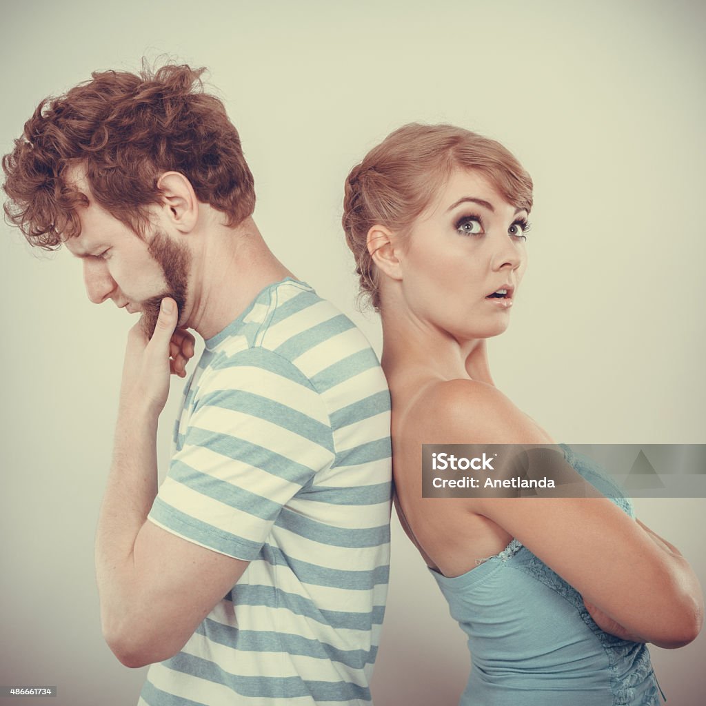 Young couple after quarrel offended back to back Bad relationship concept. Man and woman in disagreement. Young couple after quarrel offended back to back, not speaking to each other 2015 Stock Photo