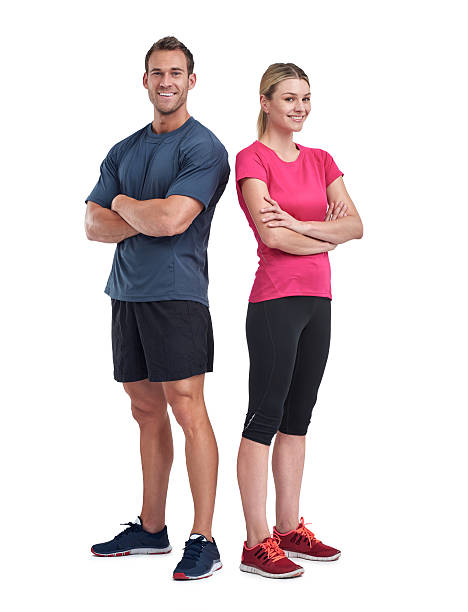 Friends in fitness Full length portrait of a young couple standing with their arms folded against a white backgroundhttp://195.154.178.81/DATA/i_collage/pu/shoots/805494.jpg sports clothing stock pictures, royalty-free photos & images