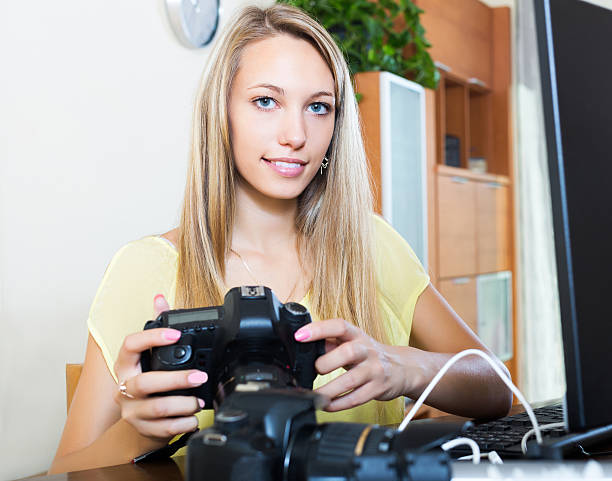 istock Smiling girl working with photocamera 486665166