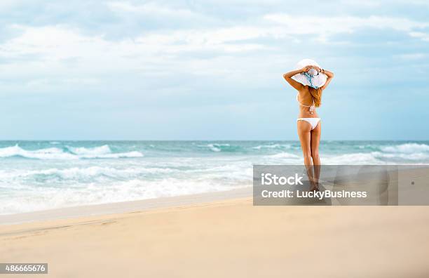 Attractive Fit Woman Standing On Beach Stock Photo - Download Image Now - 2015, Adult, Arts Culture and Entertainment