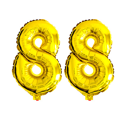 Number 88 written with golden foil balloons isolated in front of white background