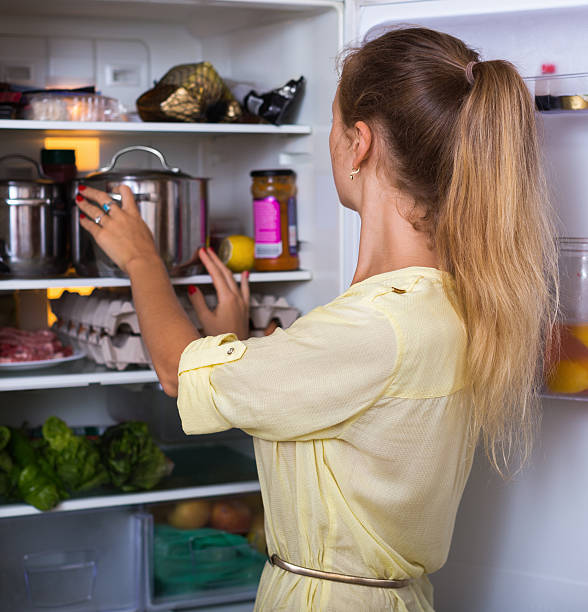 istock Housewife arranging products on fridge 486666352