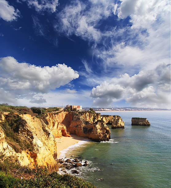 Rocky beach at sunset, Lagos, Portugal. Counter light. Travel and business background