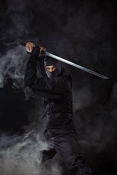 istock Ninja with sword at night in smoke 486667755
