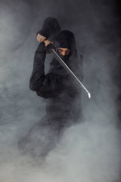 istock Ninja with sword at night in smoke 486667761
