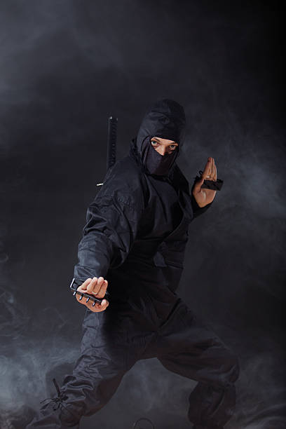 istock Ninja at night in smoke in attack position 486667779