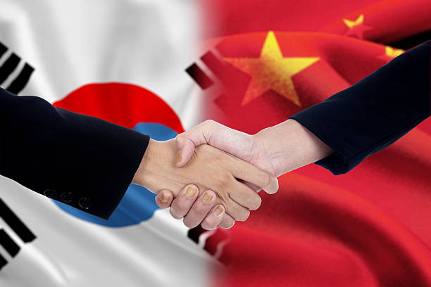 istock Politicians handshake with chinese and south korean flags 486668048